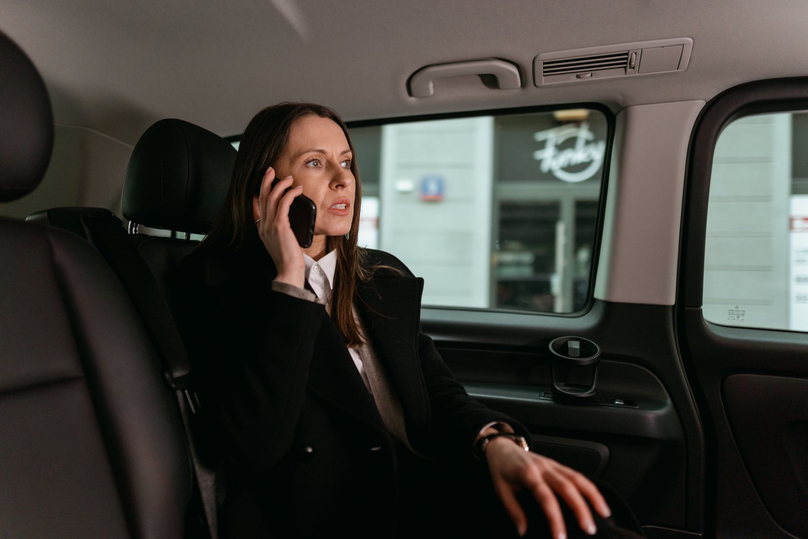 Chauffeur holding a name card at a private terminal arrival hall